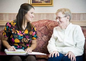Woman talking to Retired Senior
