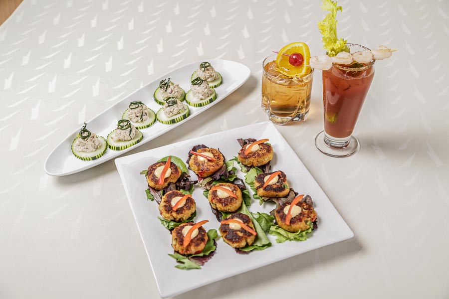 Appetizers on a plate with drinks