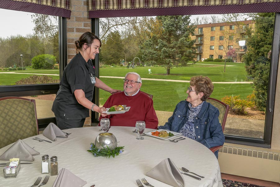Staff delivering food to guest residents