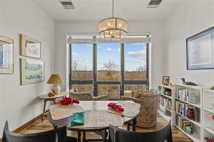 Dining area and reading corner with natural light and scenic views inside Cedar Crest Independent Living Apartment.