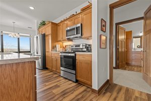 Kitchen view showing island countertop and connected bathroom area in Cedar Crest Independent Apartment
