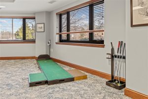 Putting green and golf practice area inside Cedar Crest senior living community activity room.