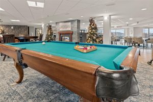Billiards table and game area with Christmas decor at Cedar Crest independent living community