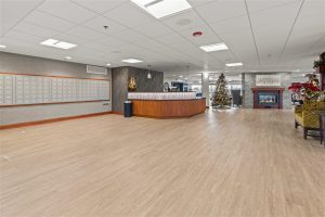 Lobby and mail area with Christmas tree and fireplace at Cedar Crest senior living community.