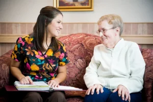 Workers sitting with a resident