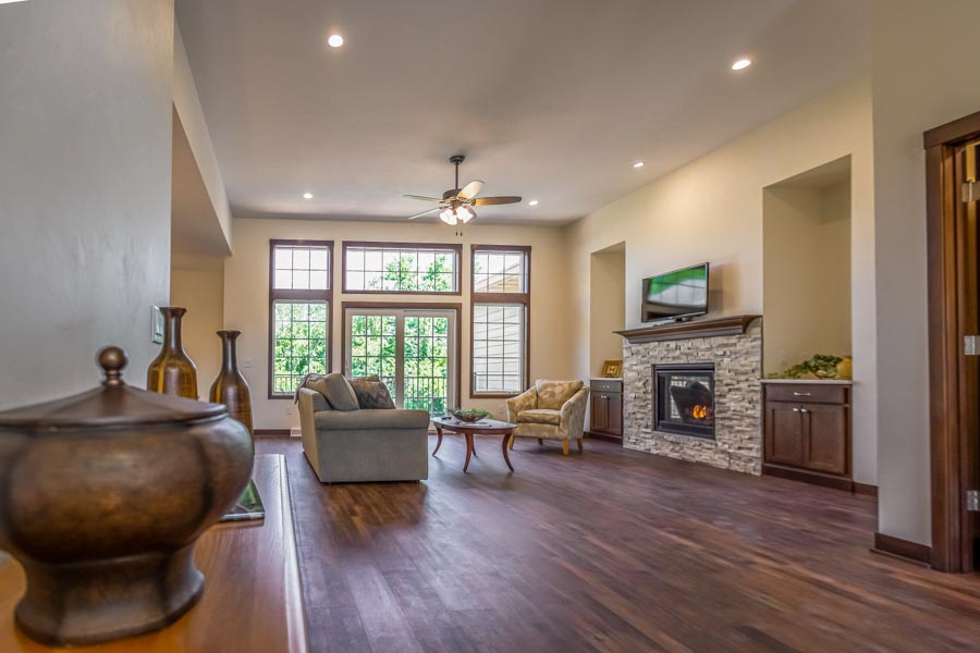 Living room with hardwood floors, fireplay and large windows