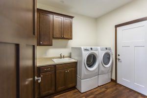 Laundry room with washer, dryer and finished cabinetry