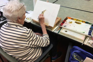 Woman painting with watercolors
